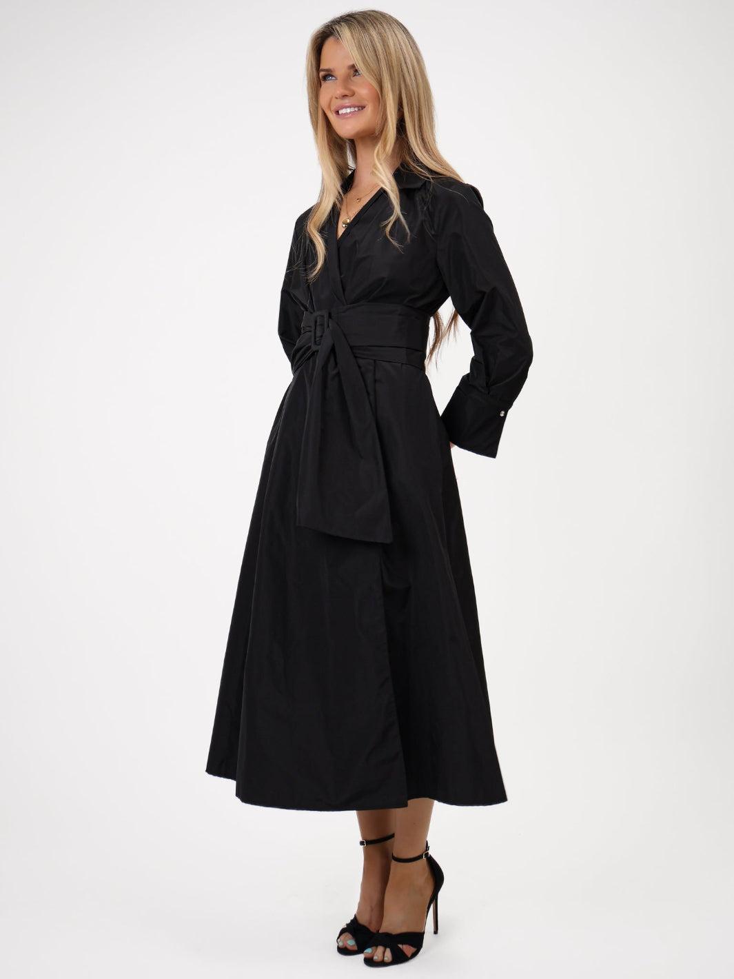 Woman wearing a black trench coat on a white background