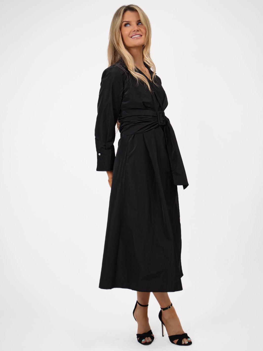 Woman wearing a black dress on a white background