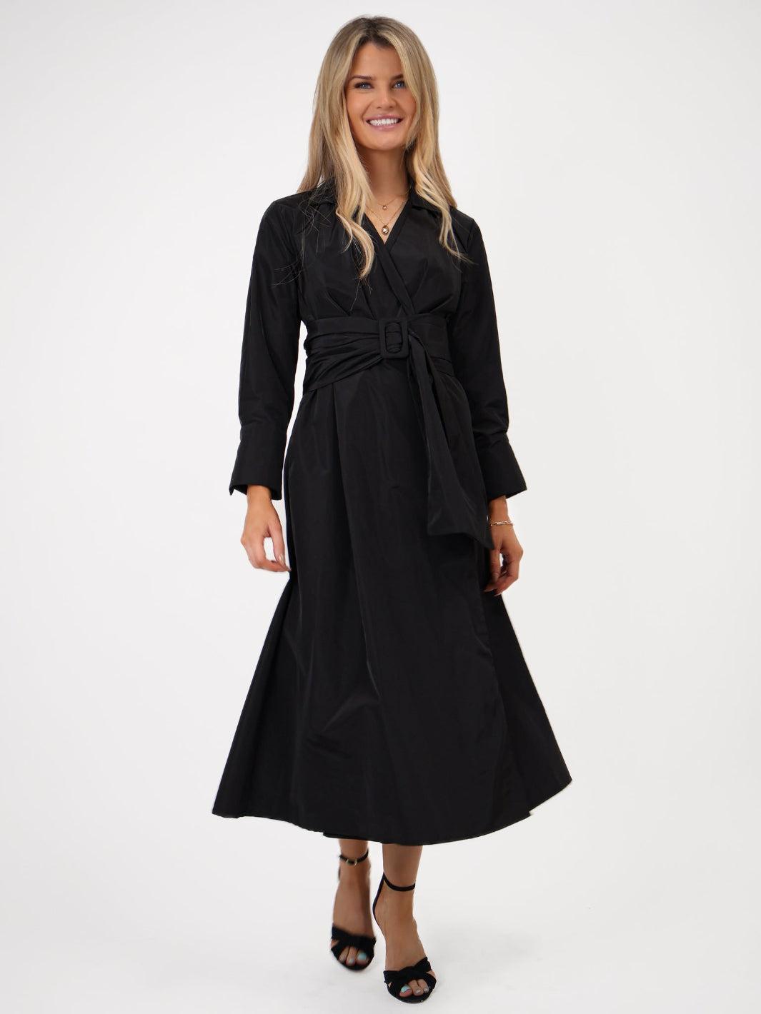 Woman wearing a black dress on a white background