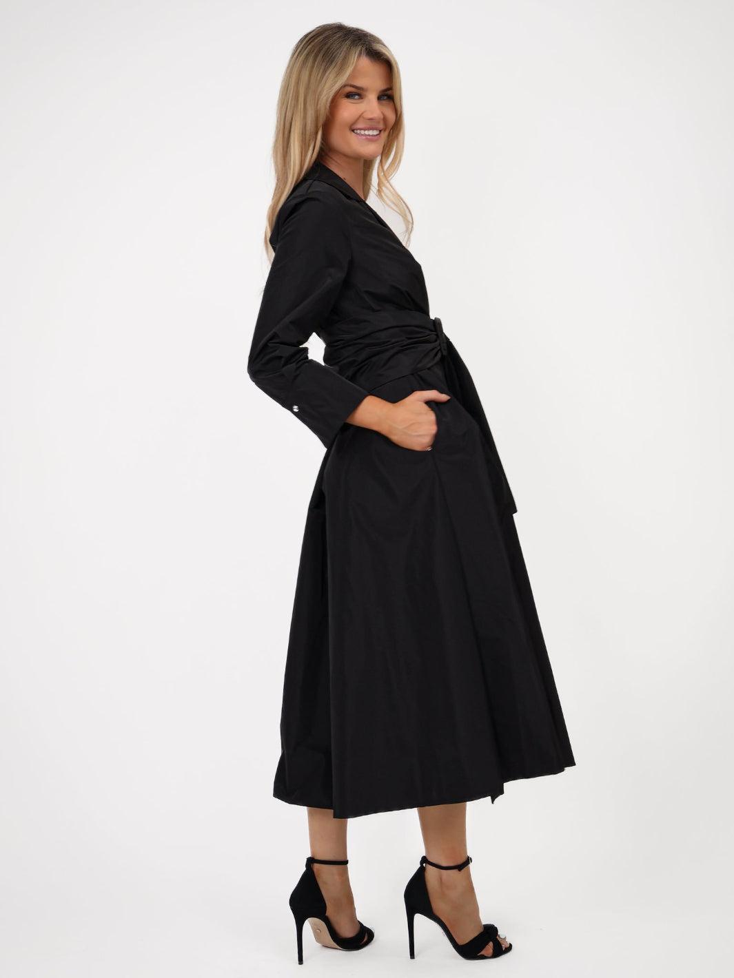 Woman wearing a black coat on a white background