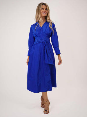 Woman wearing a blue dress with a belt on a white background