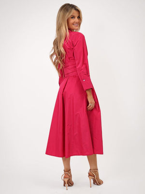 Woman wearing a bright pink dress on a white background