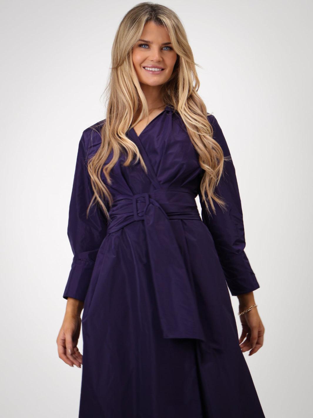Woman wearing a purple dress with a white background