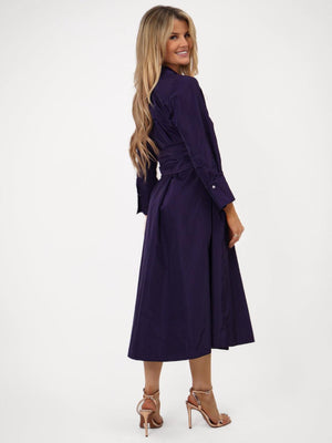 Woman wearing a purple dress on a white background