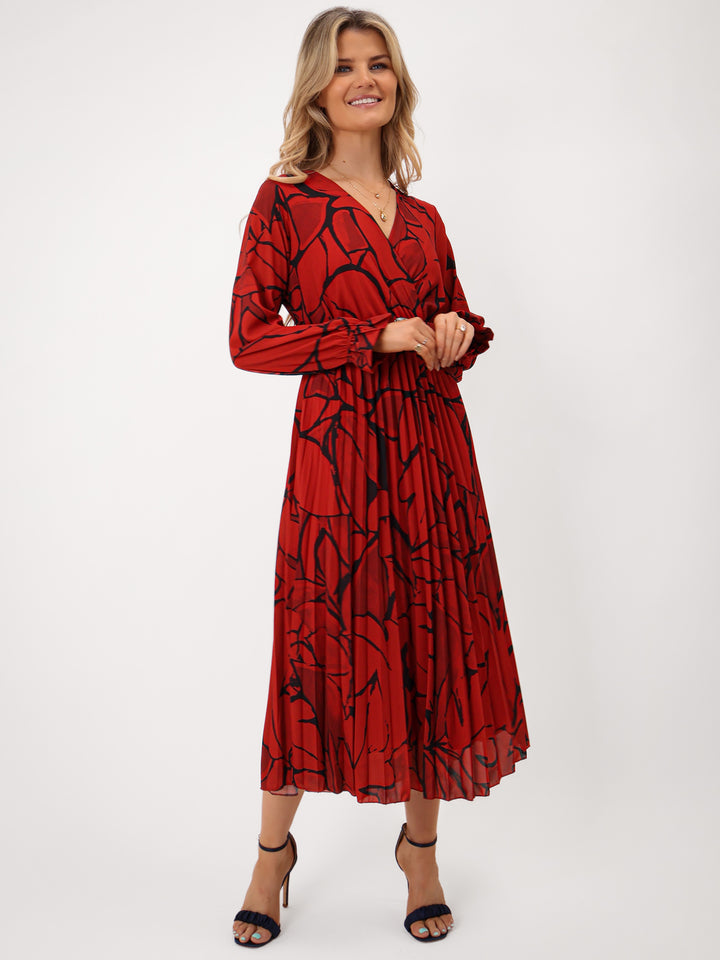 Woman wearing a red dress with black pattern on a white background