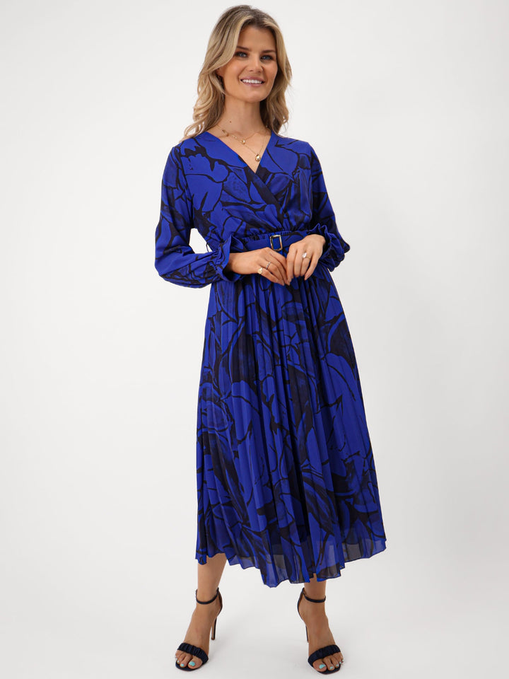 Woman wearing a blue patterned dress on a white background