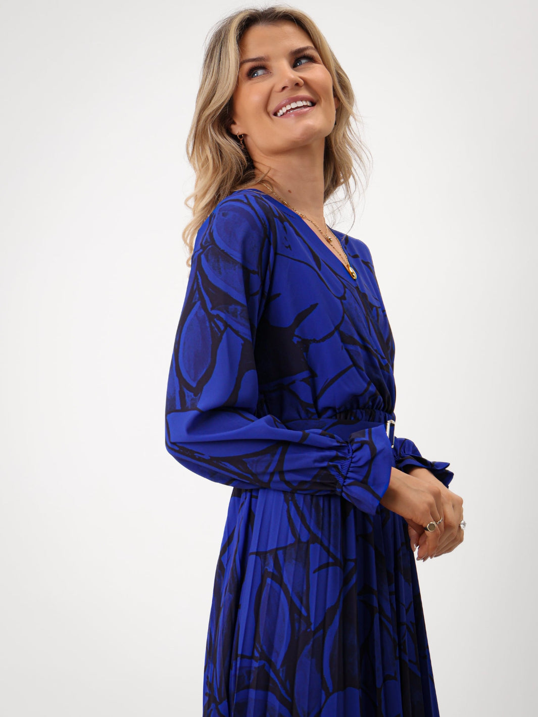 Woman wearing a blue patterned dress on a white background