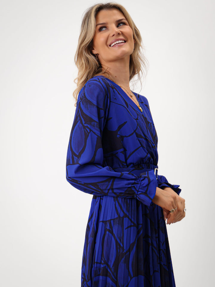 Woman wearing a blue patterned dress on a white background