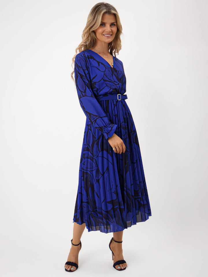 Woman wearing a blue patterned dress on a white background
