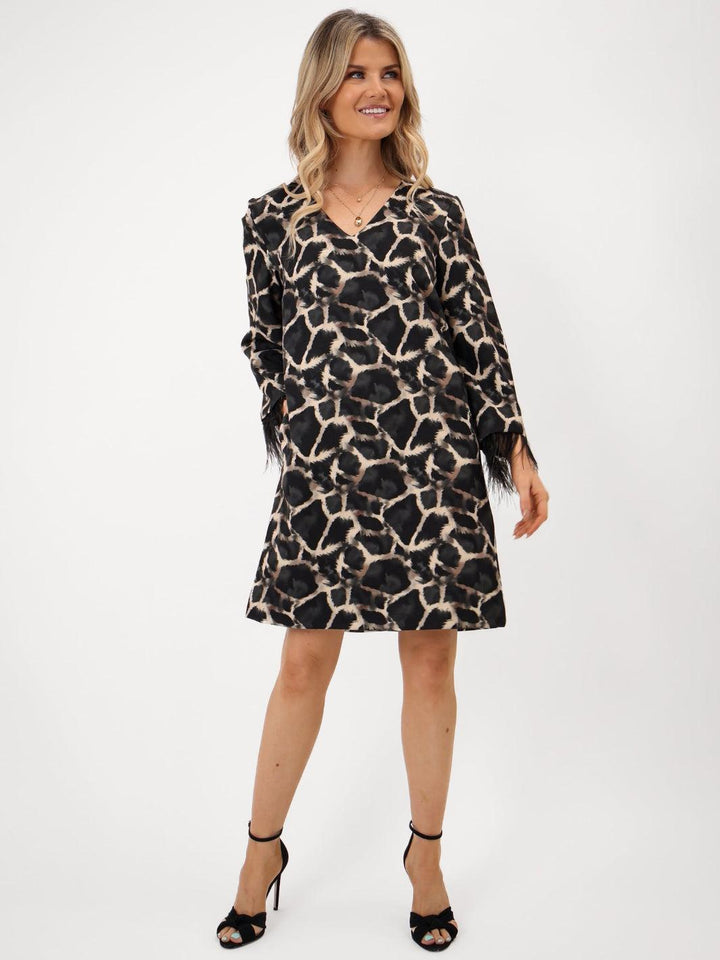Woman wearing a leopard print dress on a white background