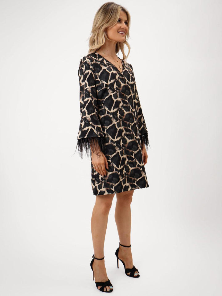 Woman wearing a leopard print dress on a white background