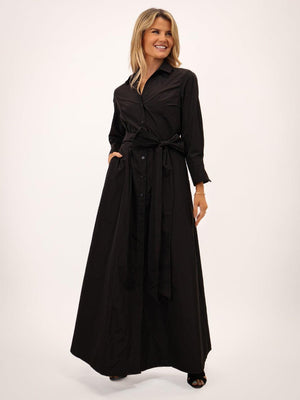 Woman wearing a black long dress on a white background