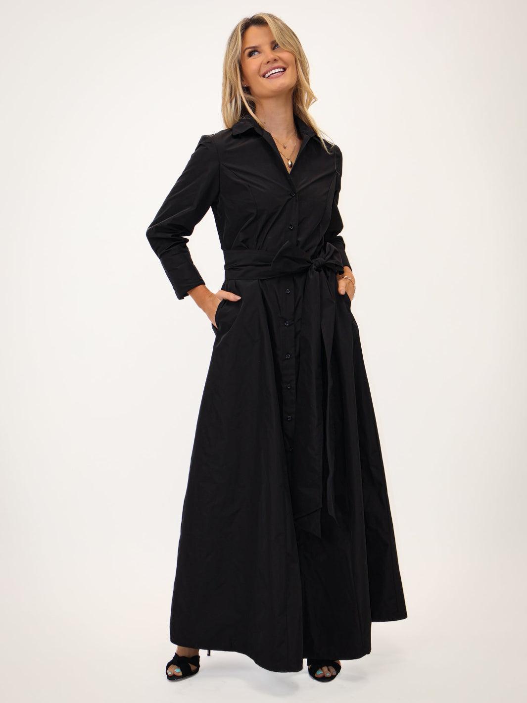 Woman wearing a black dress with a belt on a white background
