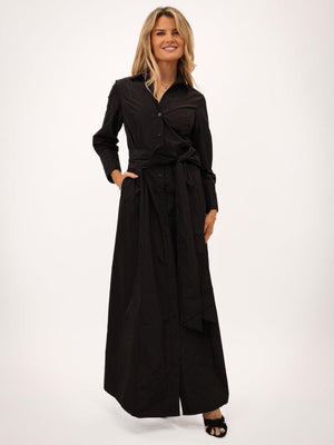 Woman wearing a black long-sleeve dress on a white background