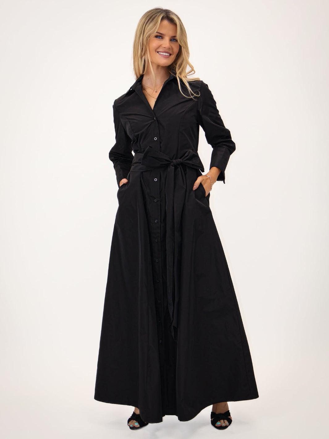 Woman wearing a black trench coat on a white background