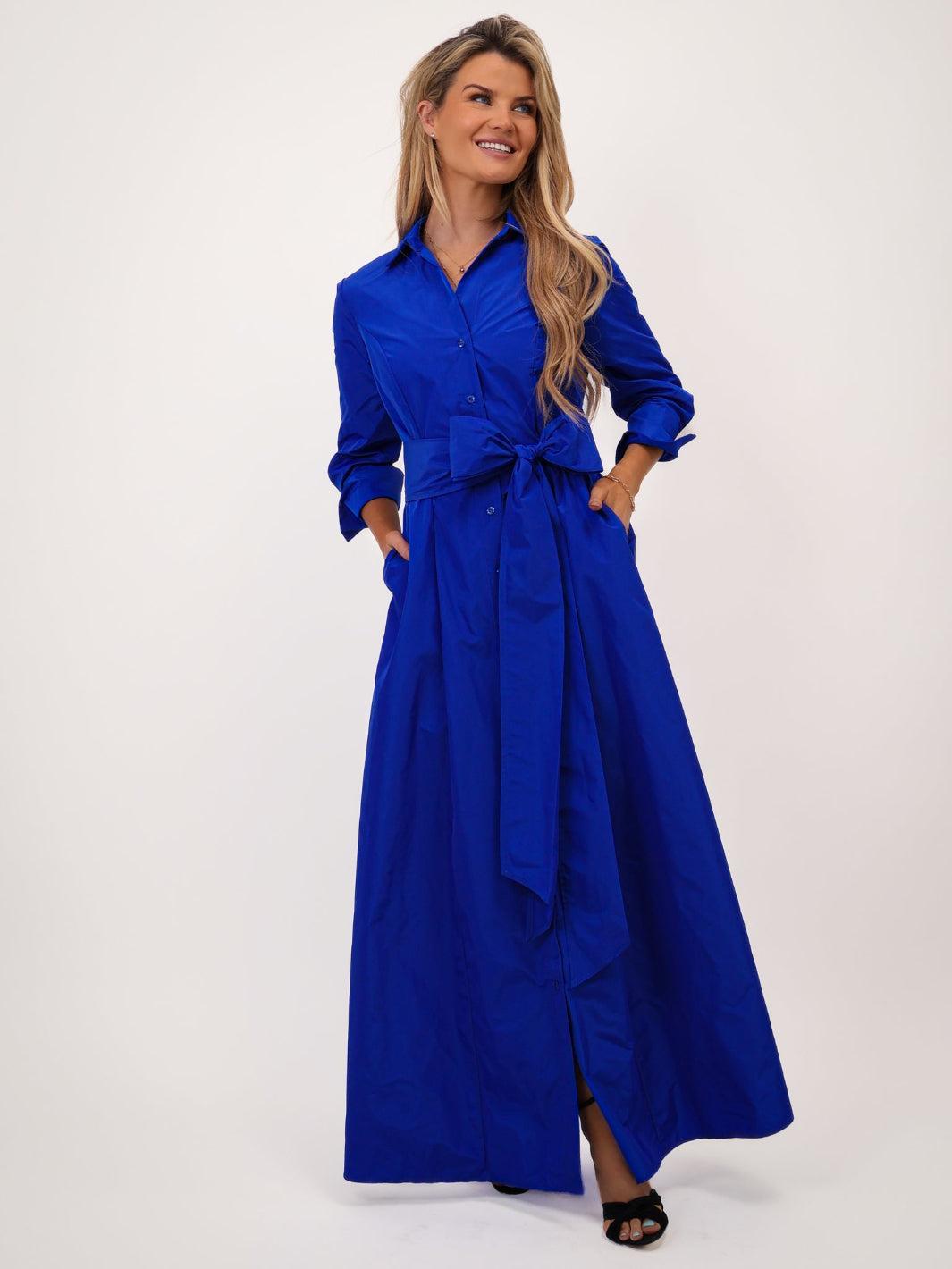 Woman wearing a blue dress with a white background