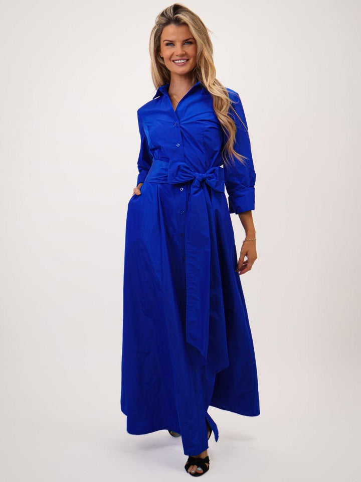 Woman wearing a blue dress with a white background
