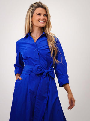 Woman wearing a blue dress with a white background