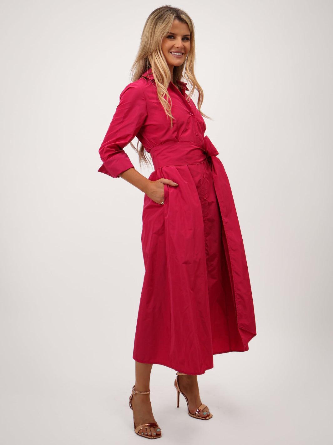 Woman wearing a pink dress on a white background