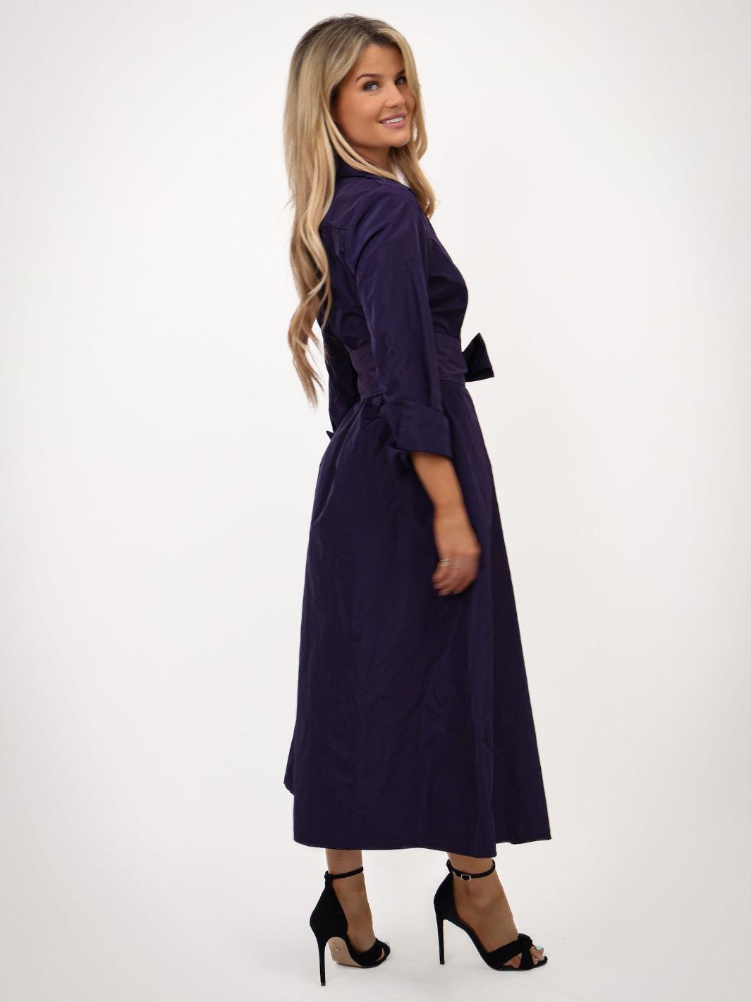 Woman wearing a purple dress on a white background