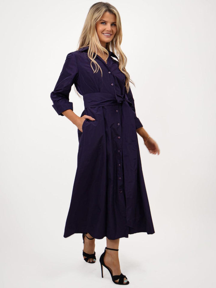 Woman wearing a navy blue dress on a white background