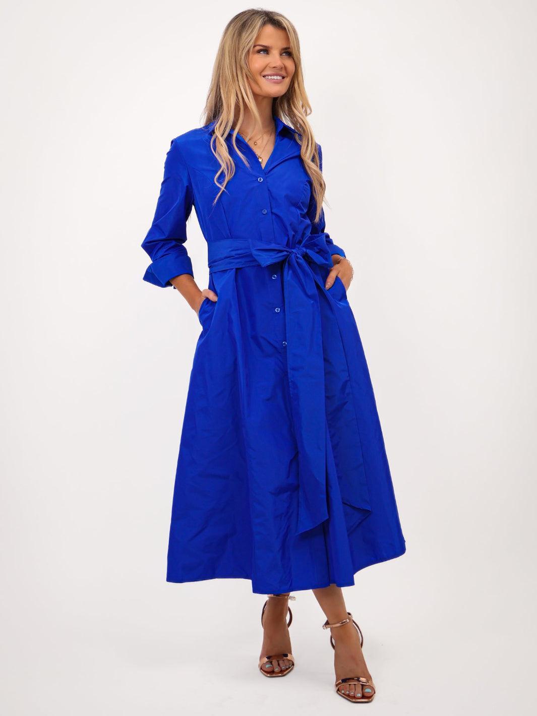 Woman wearing a blue dress with a white background