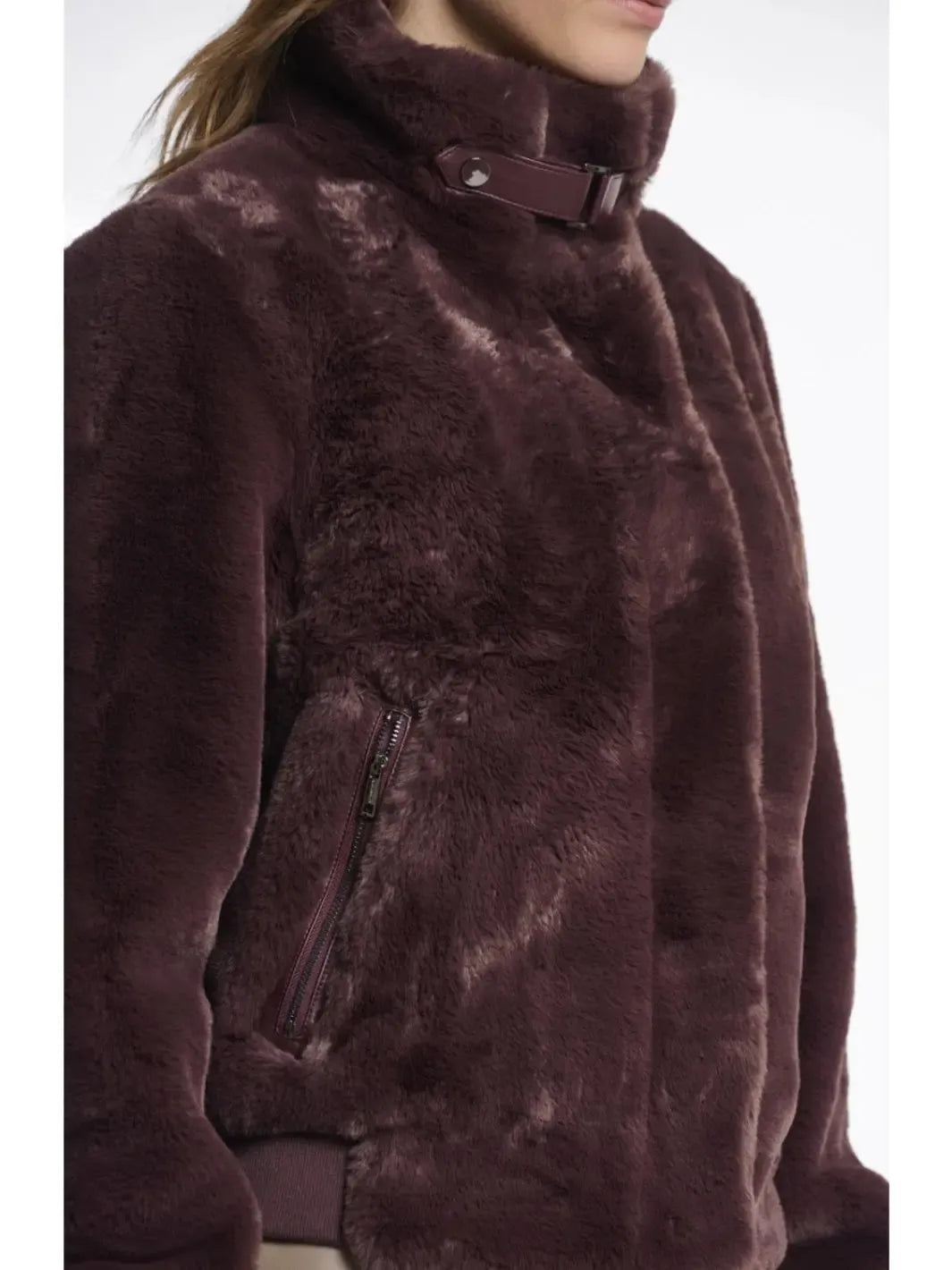 Close-up of a brown fur coat with a white background