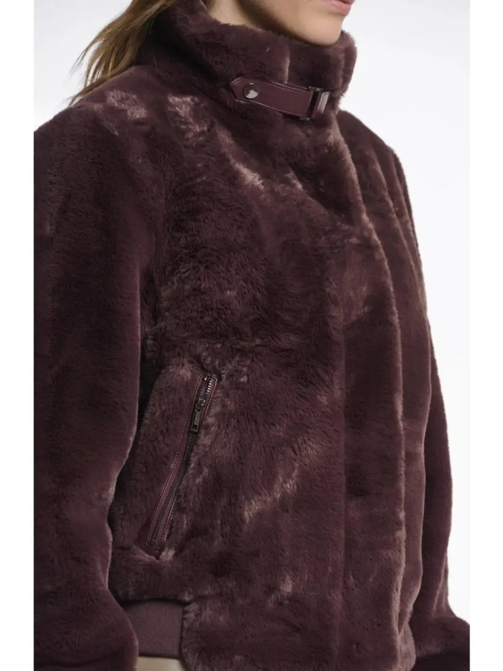 Close-up of a brown fur coat with a white background
