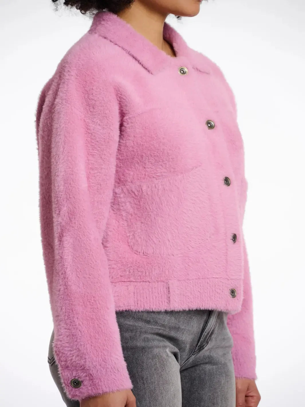 Pink textured jacket worn by a person on a white background