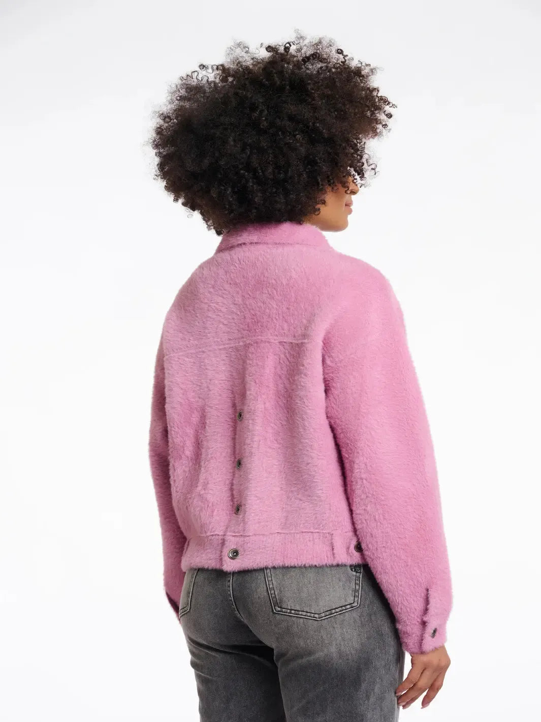 Person wearing a pink jacket on a white background