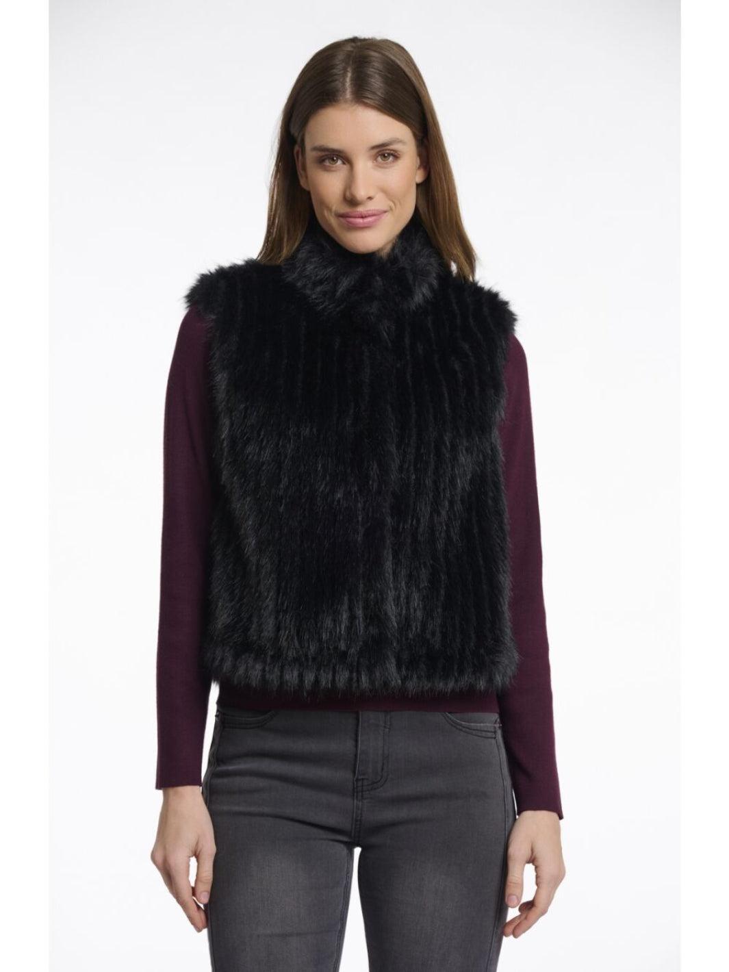 Woman wearing a black fur vest on a white background