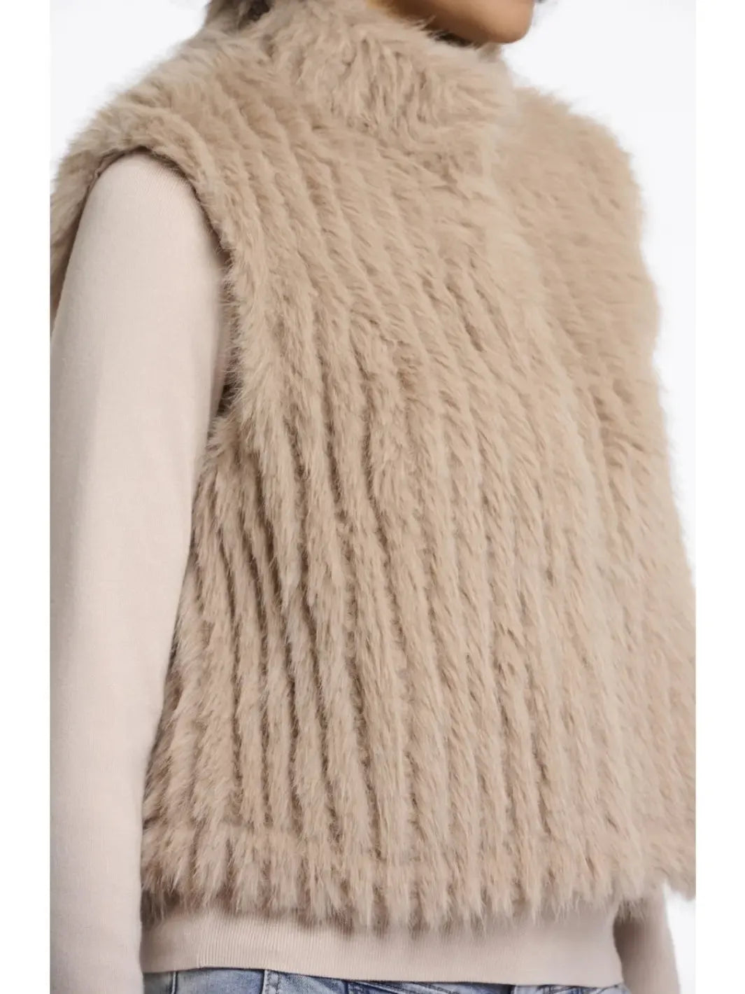 Beige fluffy vest worn by a person on a white background